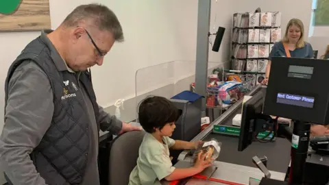 Sophie Hari on the Morrisons checkout during his birthday