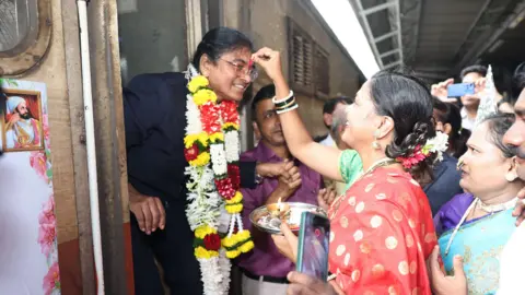 BBC Marathi is a lady who wears a valre that applies a red powder from the forehead of Mrs. Yadaf as she comes out of a train in Mumbai, India.