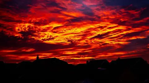 Olly/ Weather Watchers Looming red skies in Hartlepool with houses in the shadow at the lower part of the photo. 