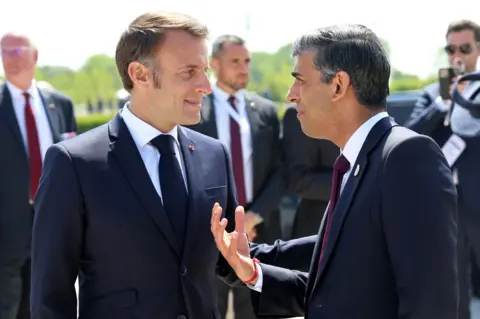 PA Prime Minister Rishi Sunak with President of France, Emmanuel Macron following the UK national commemorative event for the 80th anniversary of D-Day, in Ver-sur-Mer, Normandy, France.