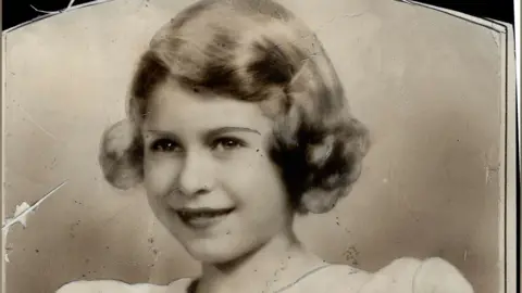 A black and white picture of young Queen Elizabeth II.