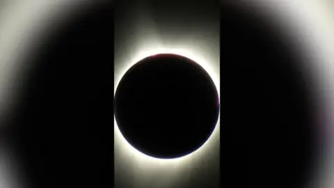 The sun covered by the moon with a ring of light around it