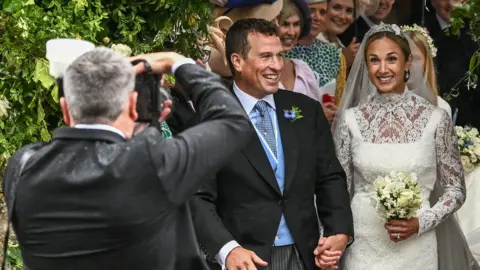 Reuters A photographer takes pictures as Princess Anne's son Peter Phillips and Harriet Sperling leave following their wedding at All Saints' Church in Kemble, Cirencester.