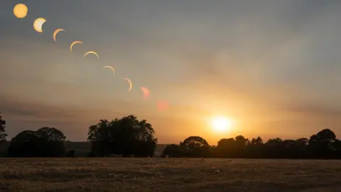 Z70 Photography/ Ian Knight A timelapse picture of the various stages of the eclipse, ending with the setting sun, over trees on Stone Common in Staffordshire.