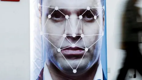 White dots and lines create points across a man's eyes, nose and mouth 