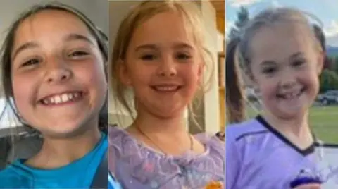 Three young girls smile
