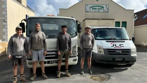 JLC Paving Four employees of JLC Paving standing in front of two vans outside the Amalgamated Boxing Club