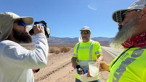 Andrew Kelly Kelly takes on fluids beside the road during the 135-mile (217km) Badwater ultramarathon through Death Valley. 