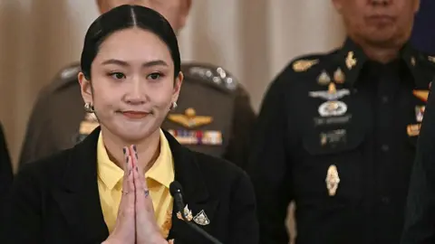 Getty Images Thai Prime Minister Paetongtarn Shinawatra gestures at a press conference