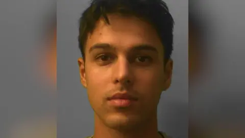 Sussex Police A police mugshot of Alex Patel-Wells