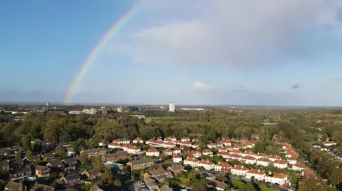 Getty Images Aerial shot of Basingstoke, a built-up area with lots of houses. There is a rainbow in the sky.