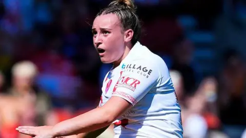 St Helens player Luci McColm in kicking action.