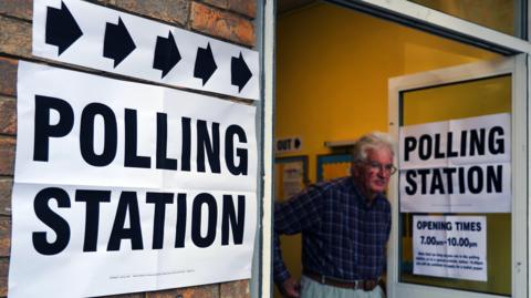 Man standing at a polling station
