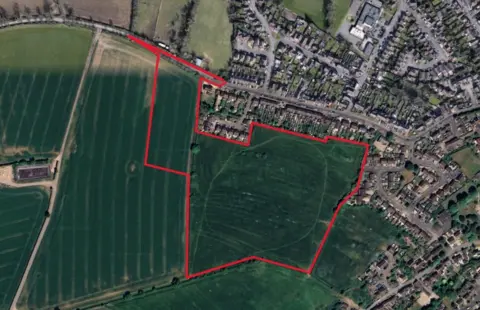 Google An aerial shot of Google Maps which shows a field outlined in red.