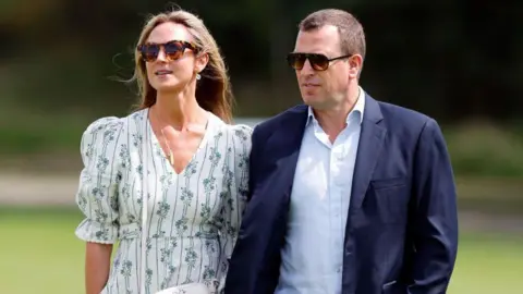 Max Mumby/Indigo via Getty Images Harriet Sperling wears a patterned green and white dress, while Peter Phillips wears a light shirt and dark jacket