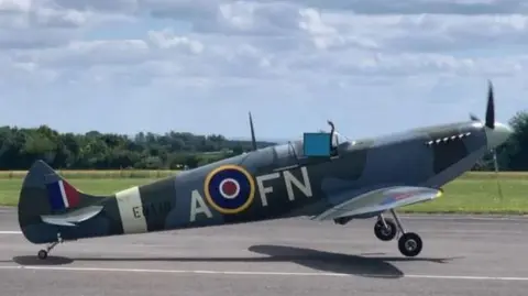 A side view of the Spitfire at takeoff, with its wheels a short height off the ground