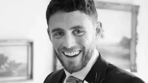 A black and white photo of PC Andrew Harper