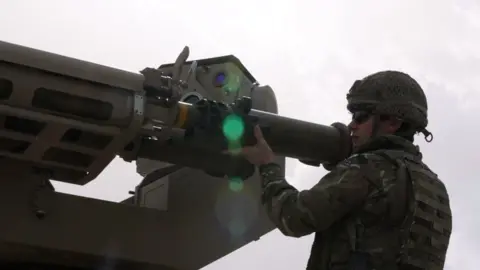 Soldier putting missile in tube