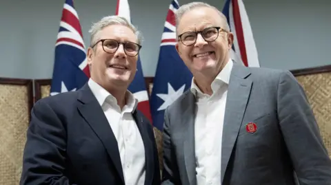 Reuters Sir Keir Starmer and Australian Prime Minister Anthony Albanese met during the Commonwealth Heads of Government Meeting in Samoa in October last year. The two are pictured in front of union flags and Australian flags.