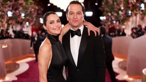 Keri Russell and Matthew Rhys hugging and smiling at the camera