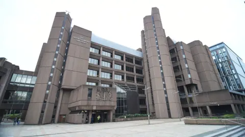 PA Media Liverpool Crown Court, which is a six storey building with a brown concrete exterior