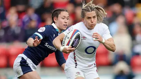 Claudia MacDonald of England breaks past Rhona Lloyd and Chloe Rollie of Scotland during the Guinness Women's Six Nations 2025 match