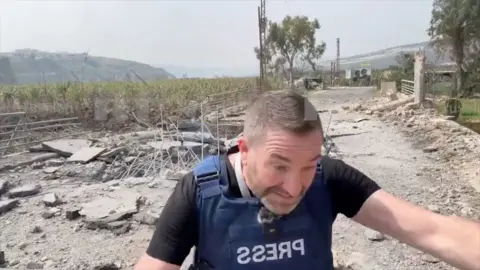 A still from a video of a British journalist ducking for cover from an Israeli strike in Lebanon.