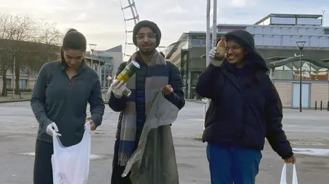 Vivek Gurav / PA Media Vivek and two friends litter picking 