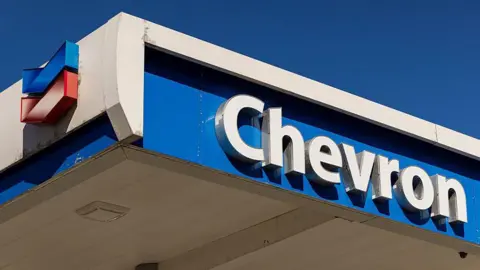 Bloomberg via Getty Images A Chevron logo on the roof of a petrol station