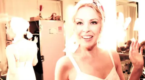 Kylie Minogue / EMI Backstage connected  the 2011 Aphrodite: Les Folies Tour, Kylie fashioned her ain  merchandise into a makeshift turban