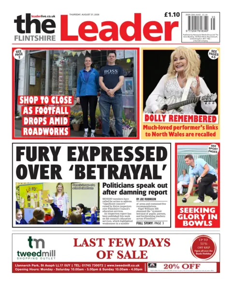 The Flintshire Leader Front page of The Flintshire Leader. The headline reads 'fury expressed over betrayal' followed by a sub headline, which reads 'politicians speak out after damming report'. Above is a photo of a man and woman outside a shop window with the headline "Shop to close as footfall drops amid roadworks".