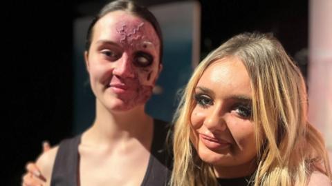 Sophie Vatore with a student made up in makeup 