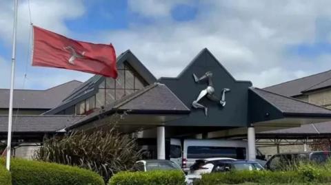 The Manx flag flying outside Noble's Hospital in Braddan