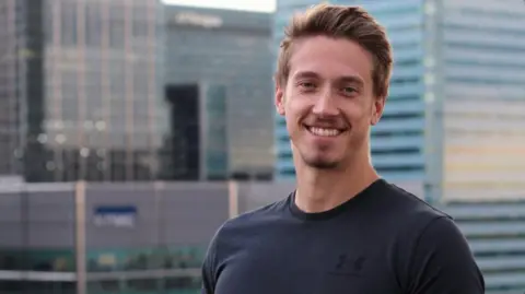 Joshua Clamp Joshua Clamp in front of skyscrapers