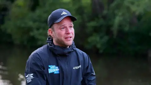 Unicef Olly Murs appearing emotional after going over the finish line