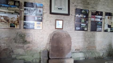 A larger Roman tombstone with a smaller stone next to it. 