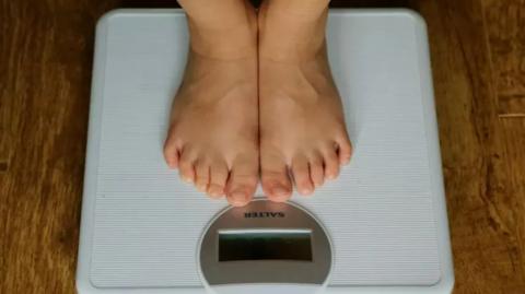 Person measuring their weight
