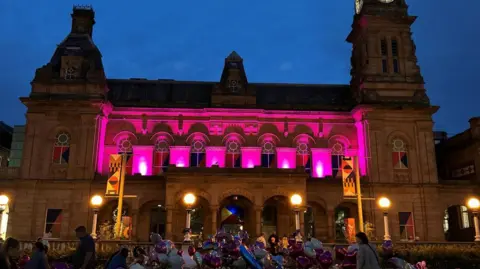 The Atkinson in Southport with its windows lighted up pink