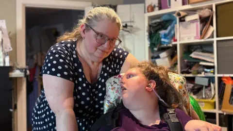BBC Rachel Steemson standing next to her daughter Charlotte at home in Birmingham