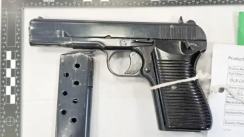 A handgun with bullet clip detached