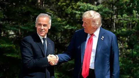 Mark Carney and Donald Trump shaking hands against a backdrop of green foliage at the G7 meeting in Alberta in June