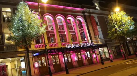 City of Wolverhampton Council The Grand Theatre at night with pink lighting outside the front of the building