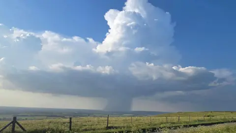 BBC Weather Watchers/Tanith A hat-shaped white thundercloud with Chippenham caught in a narrow funnel stretching to the ground.