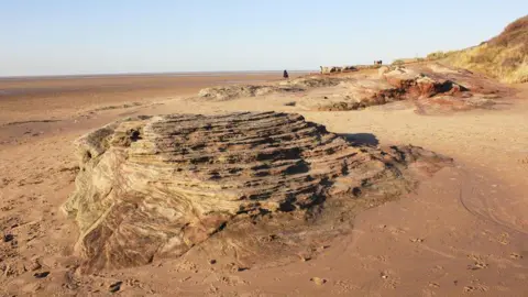 Geograph/Jeff Buck Sandstone on the a beach in Wirral showing layers of sedimentation