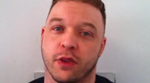 Avon and Somerset Police A close-up shot of a man with brown hair and blue eyes as his mouth is slightly open