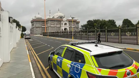 Phil Harrison/BBC A police car outside the gurdwara on Friday morning