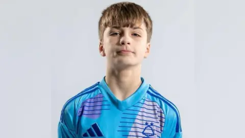 Nottingham Forest Joshua Travis wearing a blue Nottingham Forest academy shirt. 