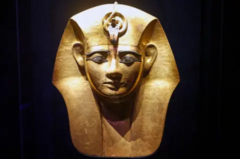 Chesnot/Getty Images File photo showing the gilded wooden funerary mask of King Amenemope, on display at the exhibition "Ramses and the Gold of the Pharaohs" at the Grande Halle of La Villette on 6 April 2023 in Paris, France
