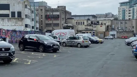 Alison Stephenson Campbell Court car park with cars parked