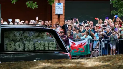 Reuters Crowds line the street as the funeral cortege passes.